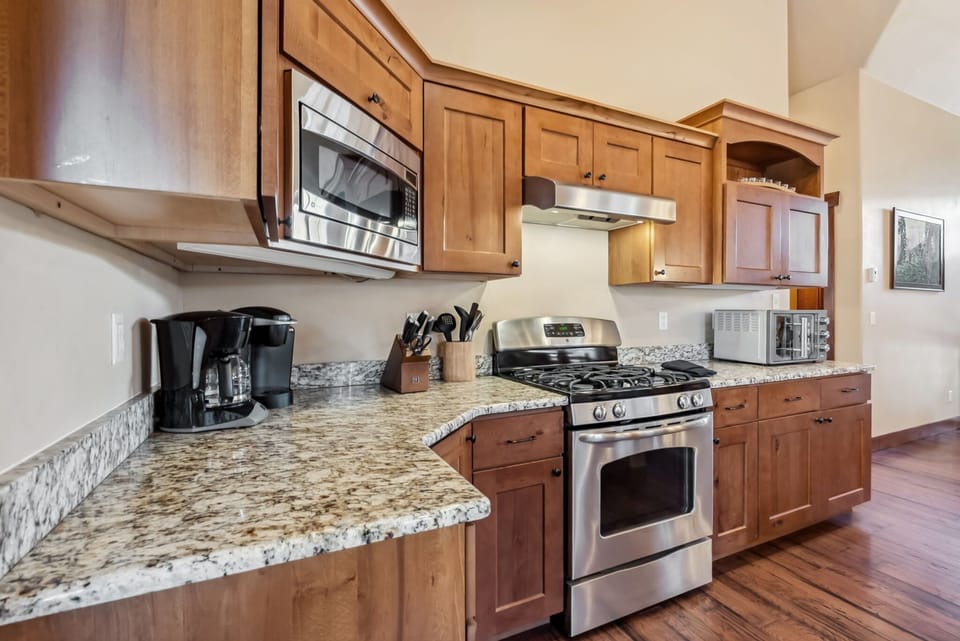 Kitchen: Main floor, drip coffee maker, Keurig, toaster, cooking utensils, tableware