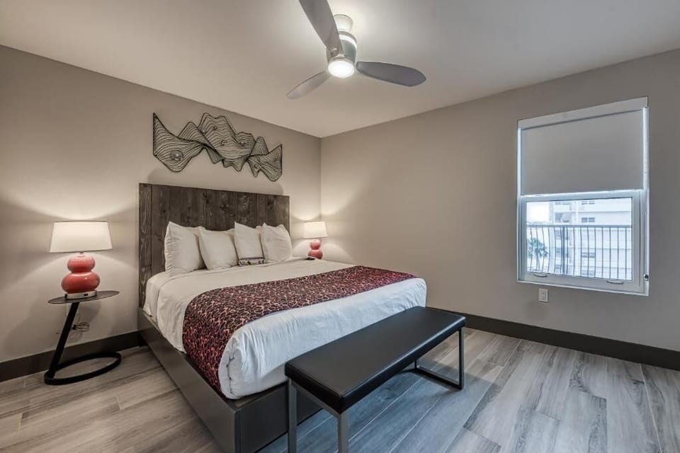 Unwind in crisp linens beneath soothing lighting and ceiling fan.