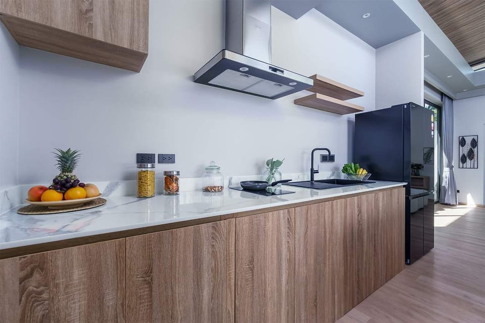 Cook in style in the fully equipped modern kitchen at Aileen Villas Layan. With sleek appliances, ample counter space, and a bright open layout, it's perfect for everything from family meals to tropical breakfast spreads. ️