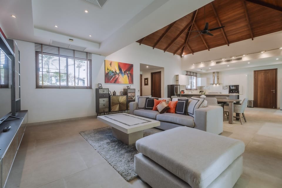 Open-plan living room with modern kitchen and elegant dining area.