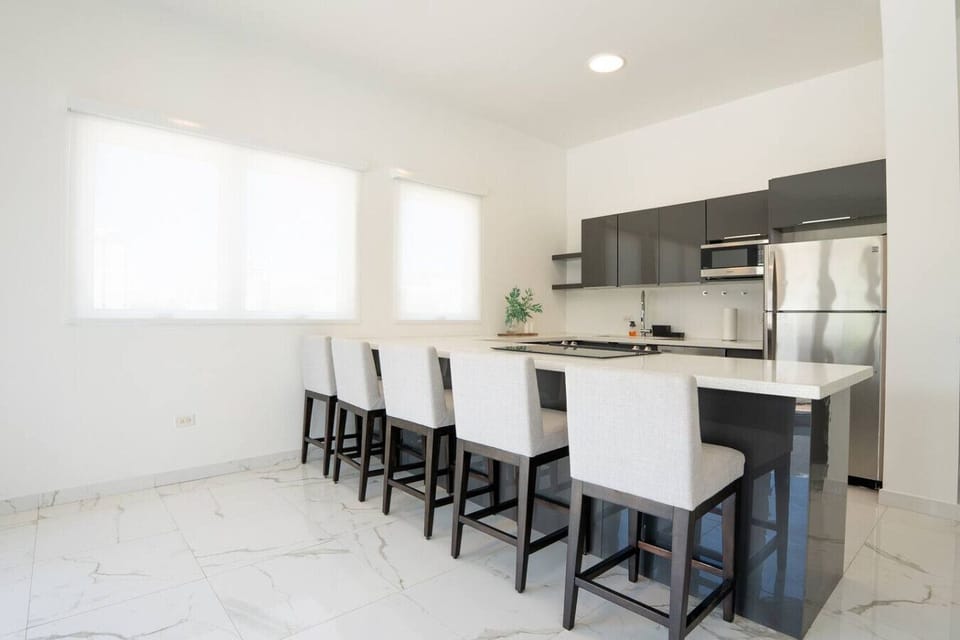 Contemporary kitchen with a sleek dining area for enjoying meals.