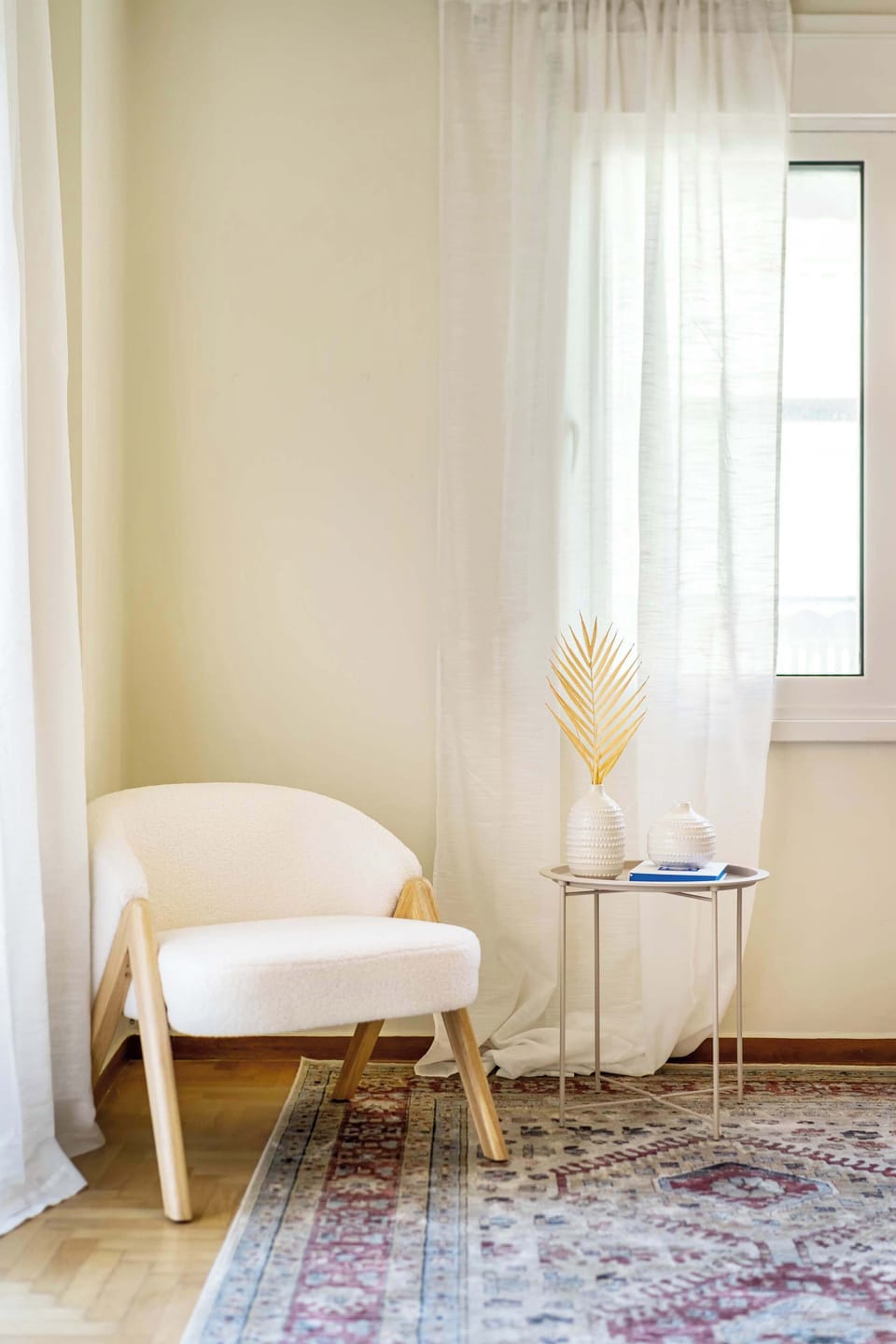 Cozy reading nook beside soft curtains, ideal for quiet moments and relaxed morning coffee.