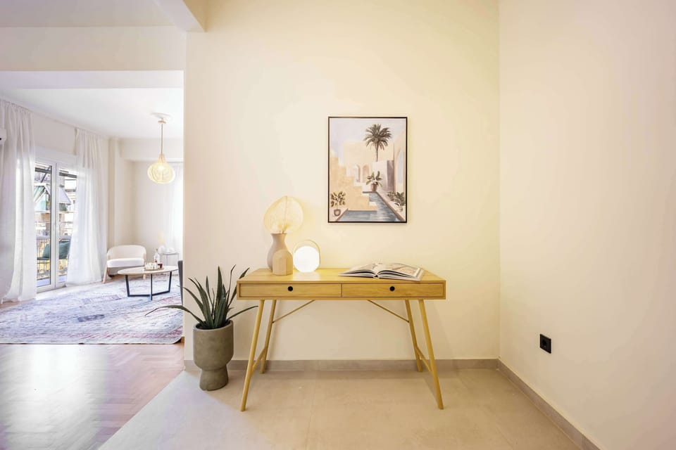 Minimal bright sleeping space with wall-mounted TV for relaxed evenings and slow mornings.