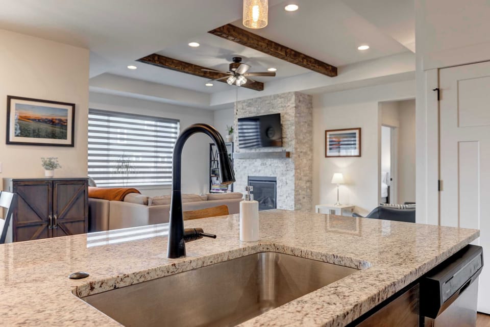 Kitchen: Fully stocked kitchen with a built-in sink in the kitchen island for cooking and entertaining.