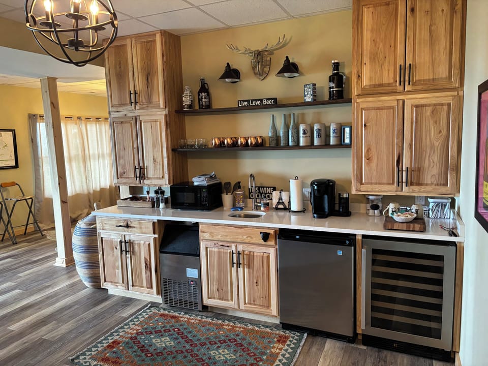 Kitchenette with fridge, ice maker, wine fridge, and fully stocked pantry.