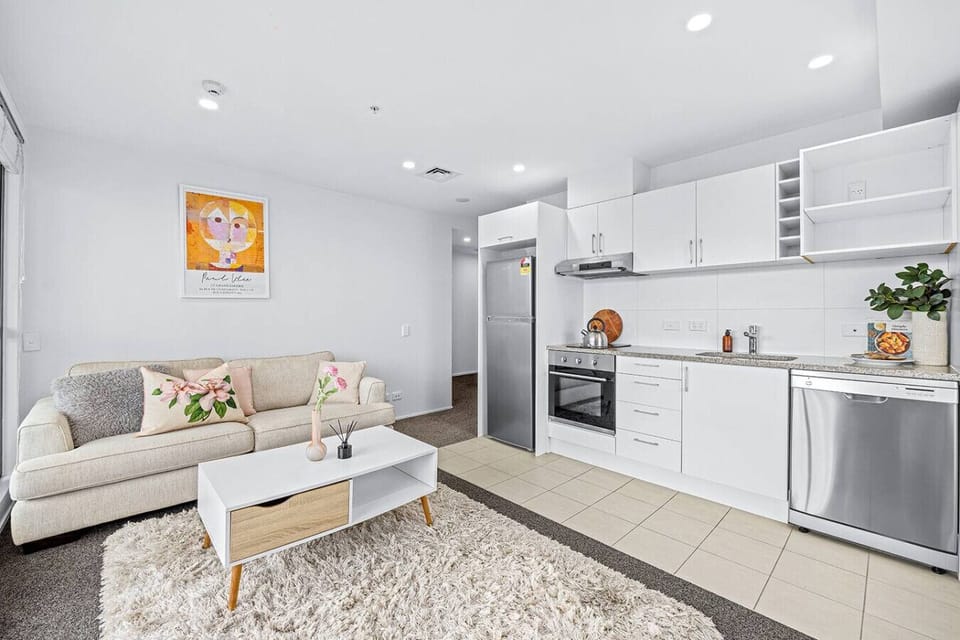 The living room is inviting with its soft furnishings and colourful artwork on the wall.