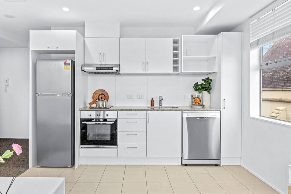 The kitchen has a dishwasher, oven, stove, microwave and fridge/freezer.