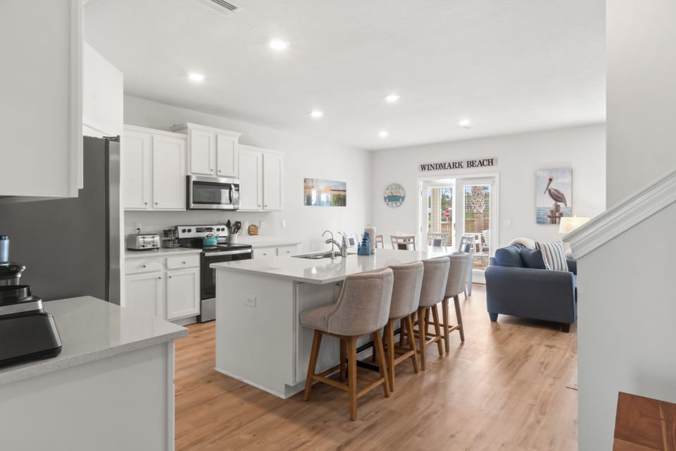 Gather around the spacious island for memorable meals in this bright, open kitchen that flows seamlessly into your cozy living area.