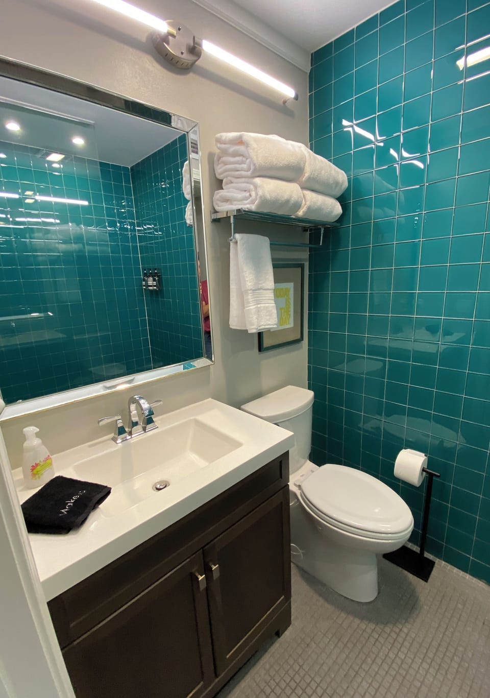 Darling bathroom with bright teal tiling