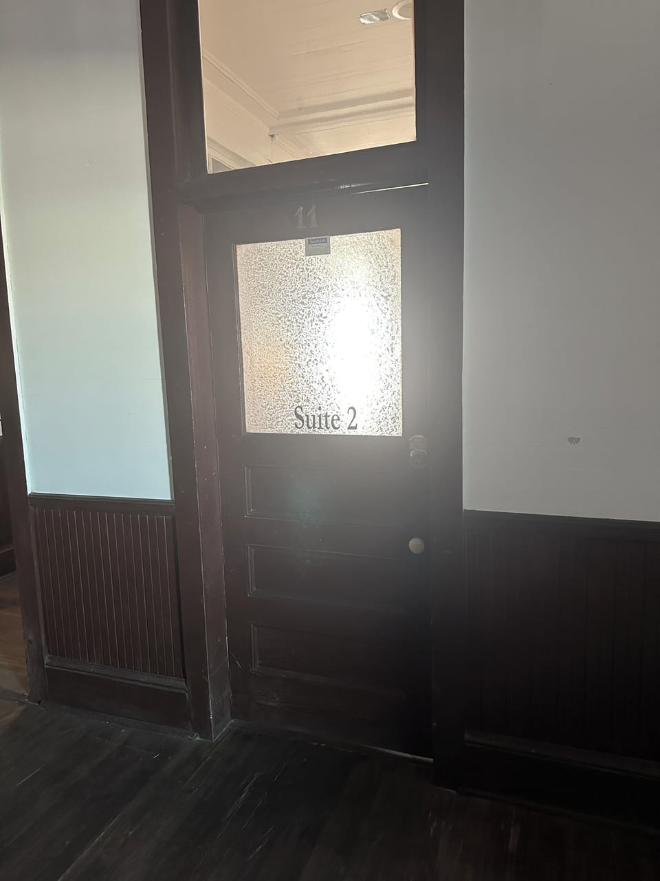 To the right at the top of the stairs, Suite 2