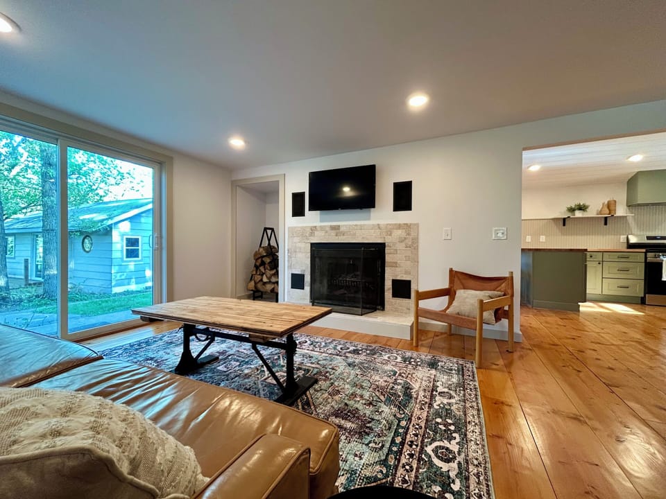 Living room with tv and fireplace. Tv has firestick for streaming