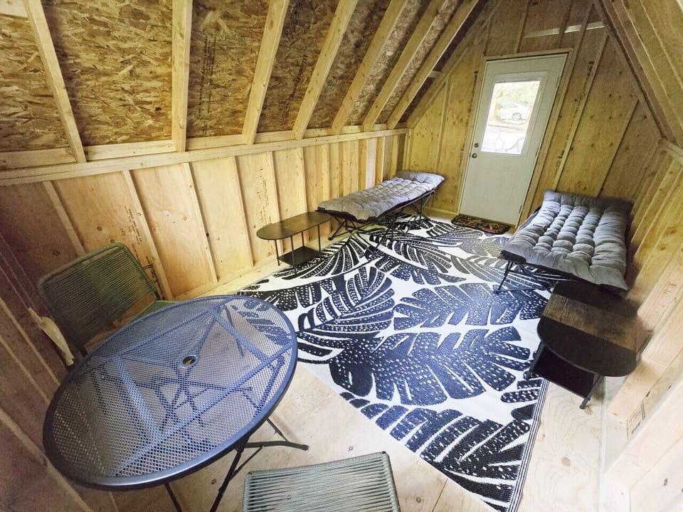 Enjoy a little seating and a table, plus two comfy cots. Please bring your own bedding!