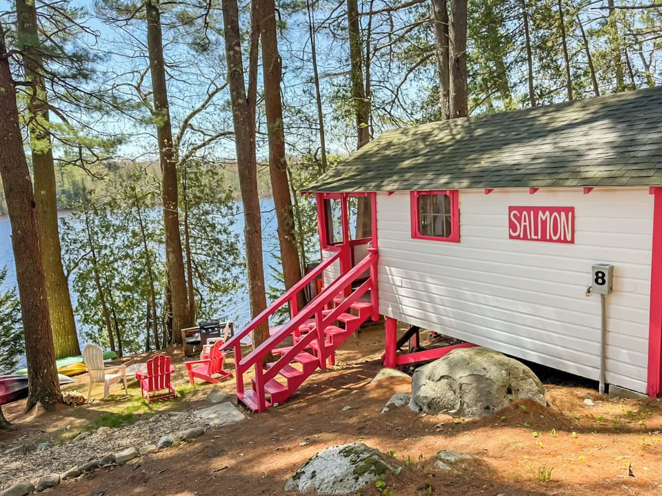 back view of the cabin, staring the stairs and the lake.