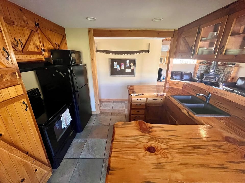 Fully equipped kitchen with sealed natural wood countertops. 
