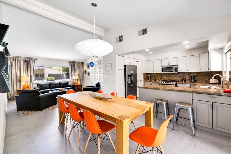 Share meals around the stylish, formal dining table that seats eight