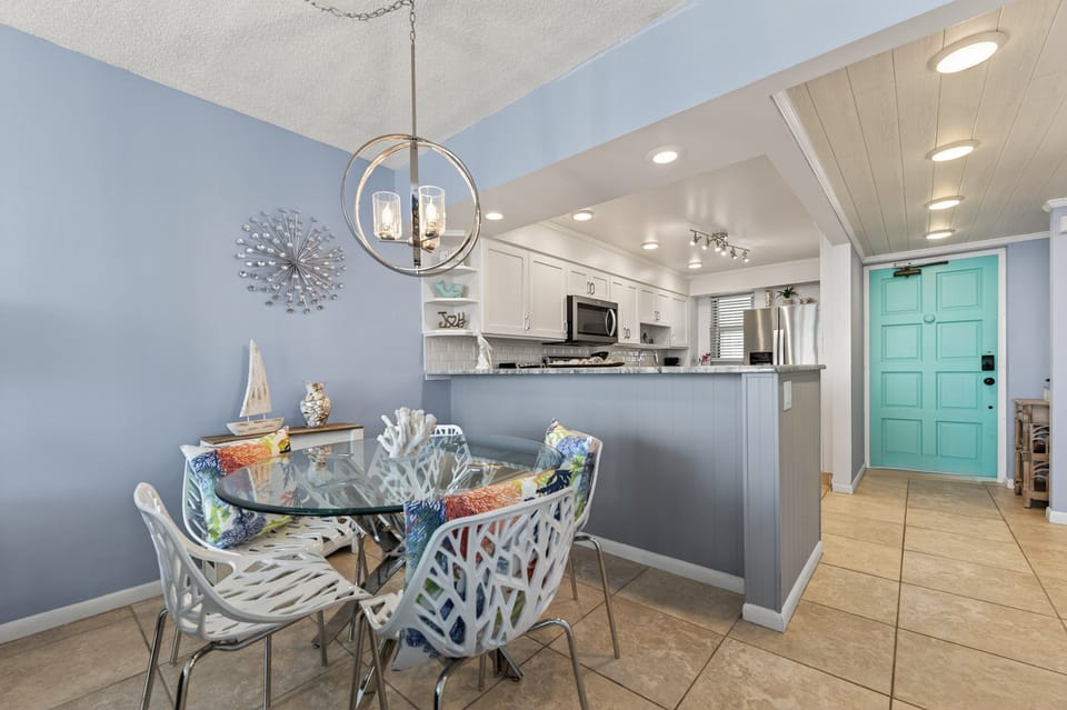 Enjoy meals in the bright, open-concept dining area with coastal charm and seating for four.