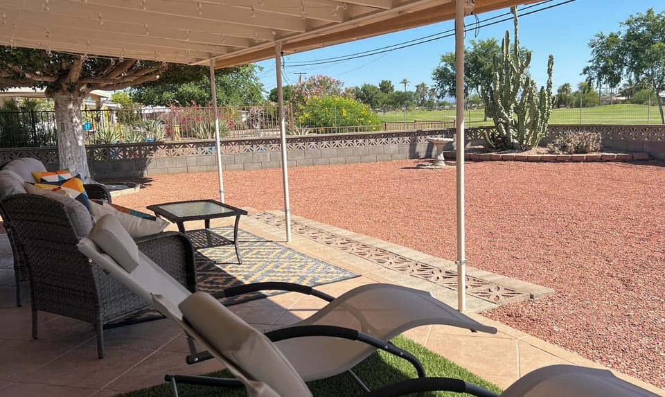 Golf course views!  Outdoor patio has roll down sun shades.
