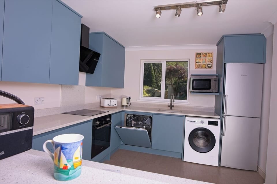 The kitchen has coffee machine, dishwasher, microwave and induction hob