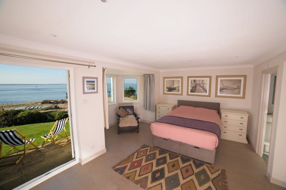 The huge master bedroom has French doors opening to a great beach-fronted view 