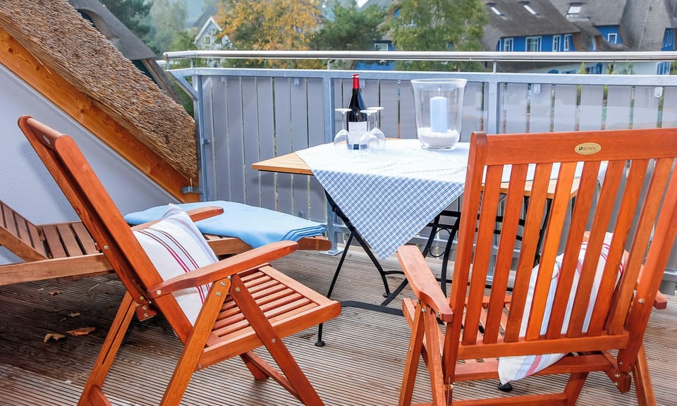 Cozy terrace with wooden chairs and wine