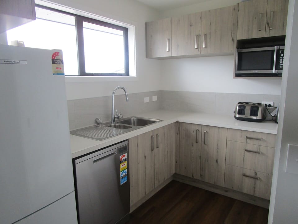 Kitchenette, twin hot plate, full size fridge, microwave, toaster & dishwasher.
