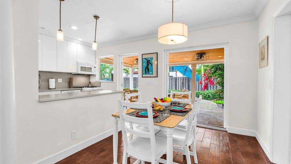 Enjoy effortless indoor-outdoor dining in this sun-filled space featuring a cozy breakfast nook, modern pendant lighting, and direct access to the lush backyard patio—perfect for morning coffee or evening meals under the stars.