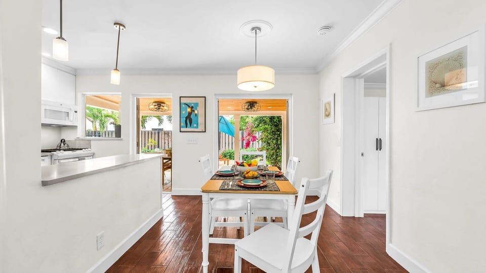 Enjoy effortless indoor-outdoor dining in this sun-filled space featuring a cozy breakfast nook, modern pendant lighting, and direct access to the lush backyard patio—perfect for morning coffee or evening meals under the stars.