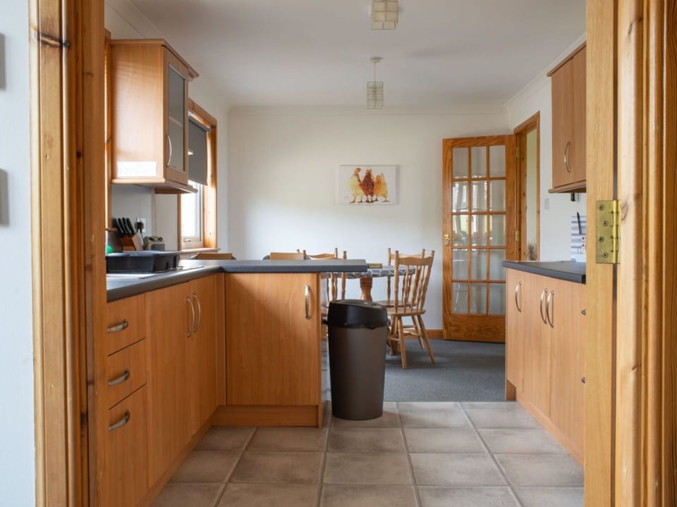 Furniture, Flooring, Interior Design, Cabinetry, Countertop, Wood, Kitchen, Floor, Room, Cupboard