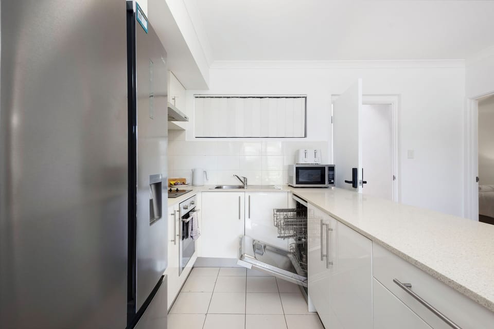 Discover a sleek and functional kitchen, equipped with appliances and ample counter space. 