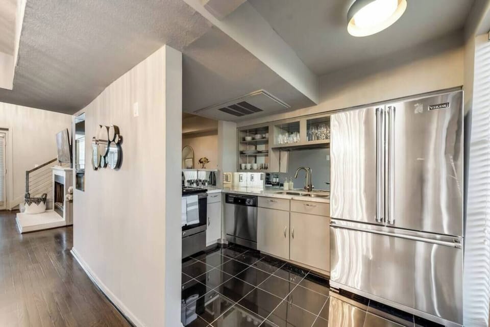 Spacious kitchen with sleek, modern appliances extra large refrigerator, fully equipped for all your cooking and dining needs.
