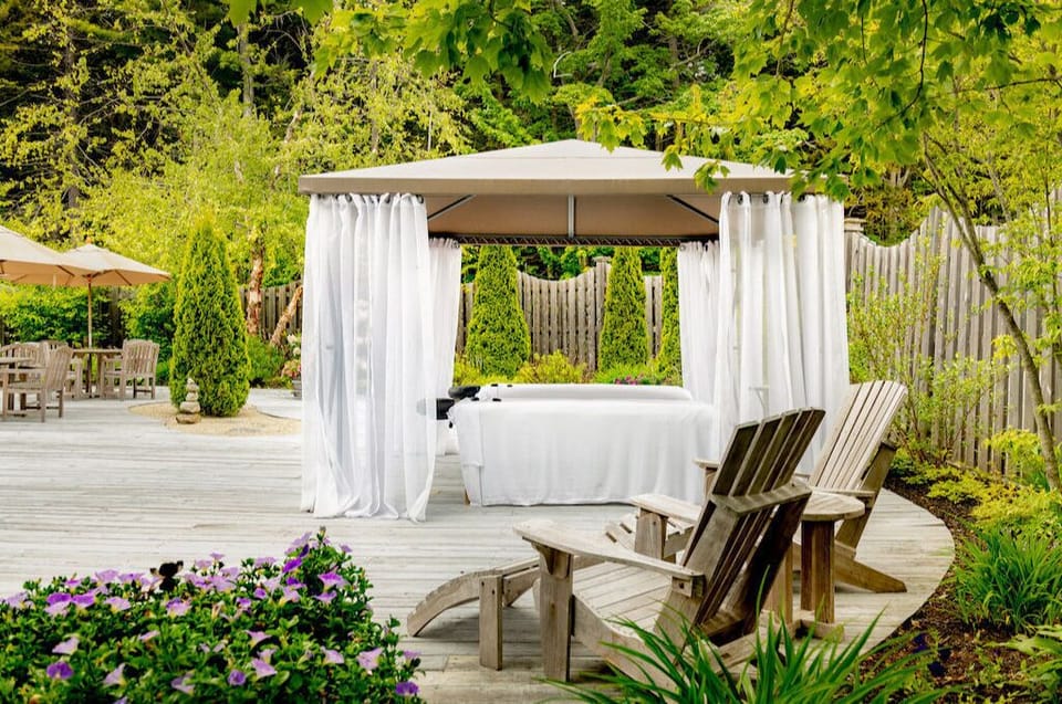 Unwind beneath billowing drapes in a private garden nook designed for peaceful moments.