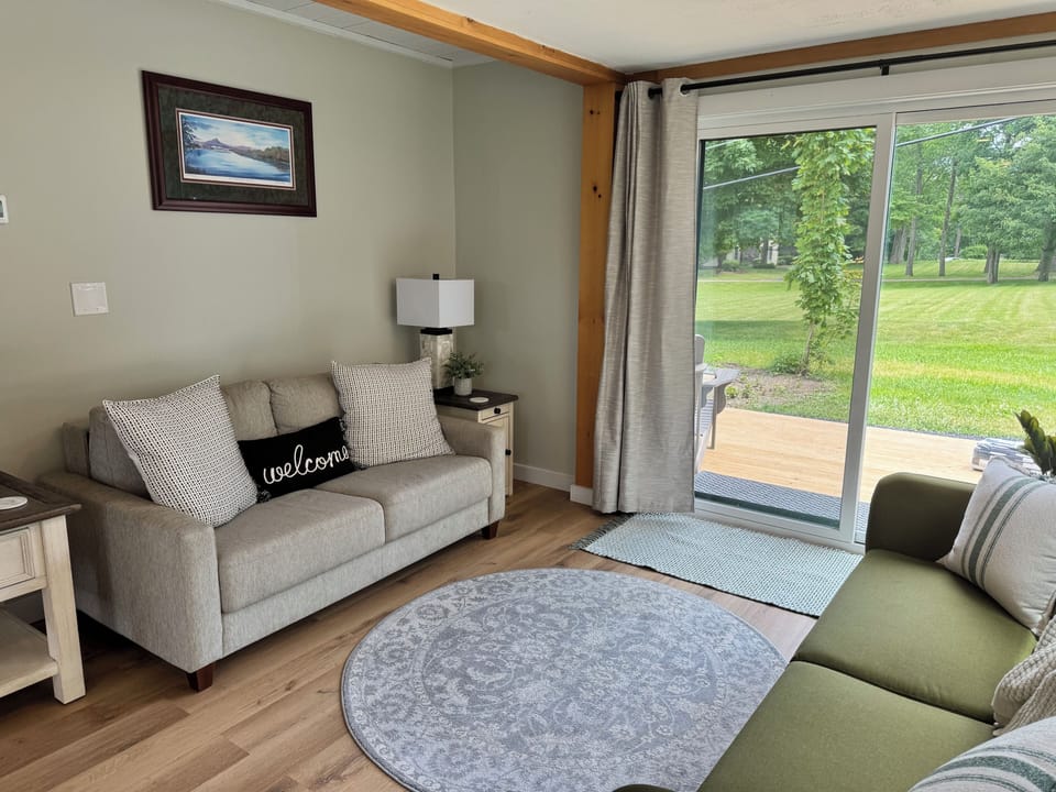 Living room with large deck and seating to enjoy the lake views