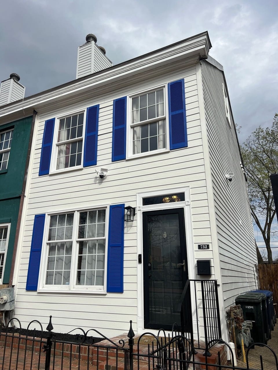 Charming Capitol Hill home with bright blue shutters and a welcoming entrance