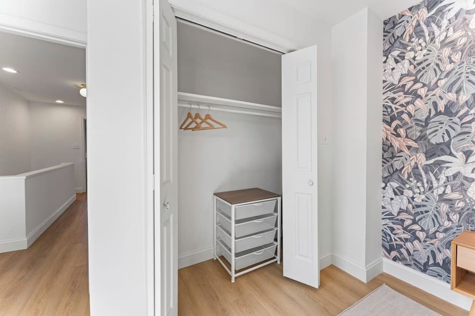 Spacious bedroom closet with hanging space and a convenient storage drawer unit