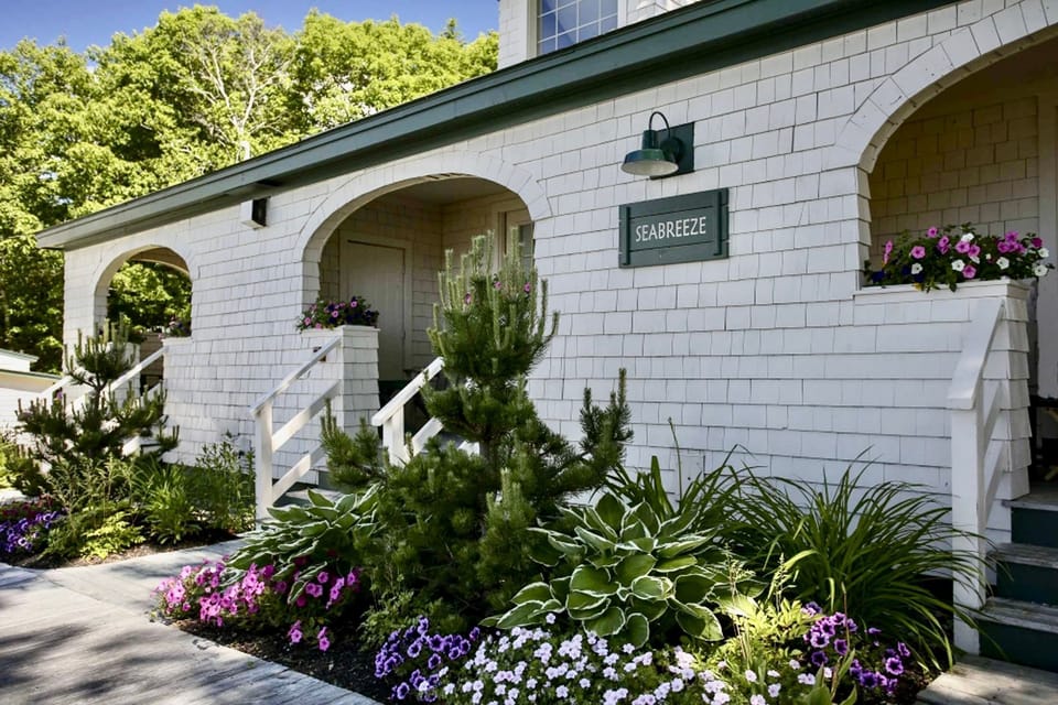 Wrapped in whitewashed charm and blooming garden beds, this inviting cottage welcomes you with storybook curb appeal.