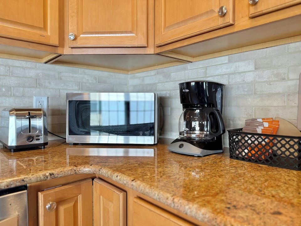 Microwave, coffee maker, and oven—ready for your meals and morning brews.