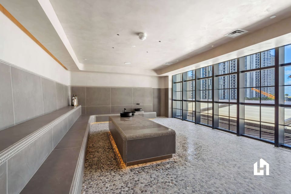 Unwind and rejuvenate in our spa featuring a serene steam room with stunning city views.