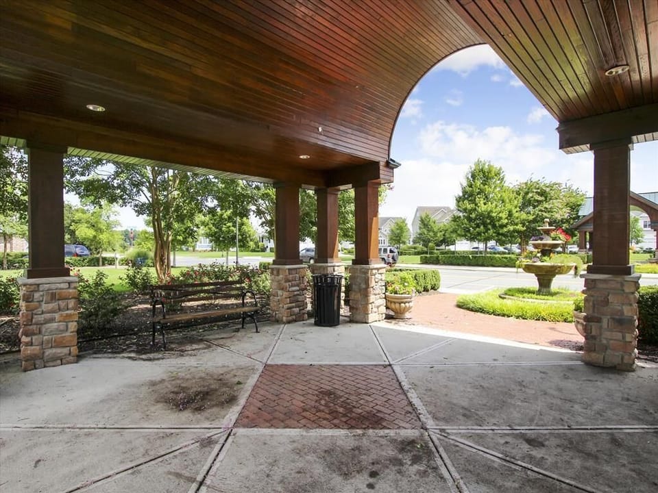 Covered outdoor pavilion with elegant stone accents, ideal for gatherings or relaxing in the shade.
