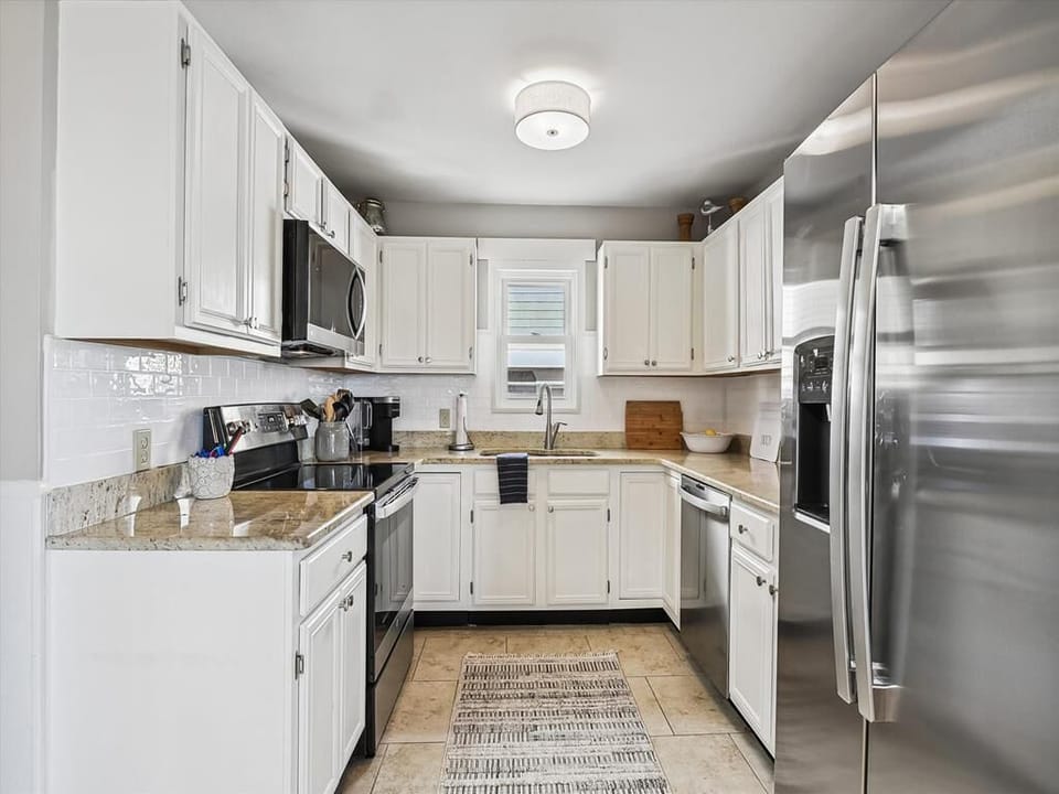 Fully equipped modern kitchen with stainless steel appliances.