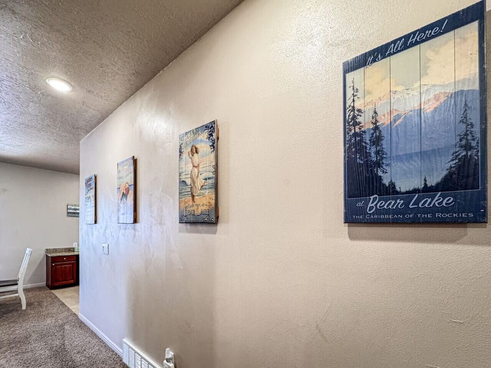 Charming Bear Lake artwork lines the hallway, bringing vintage coastal vibes to your cozy retreat.