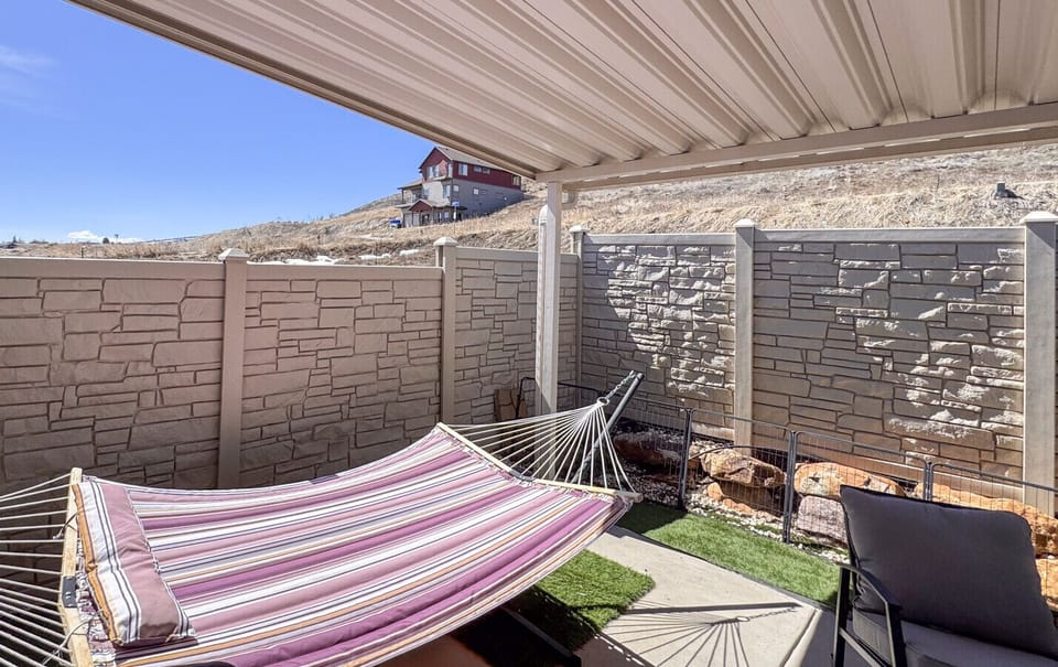 Private patio with hammock and seating. Great for relaxing under sunny, peaceful skies.