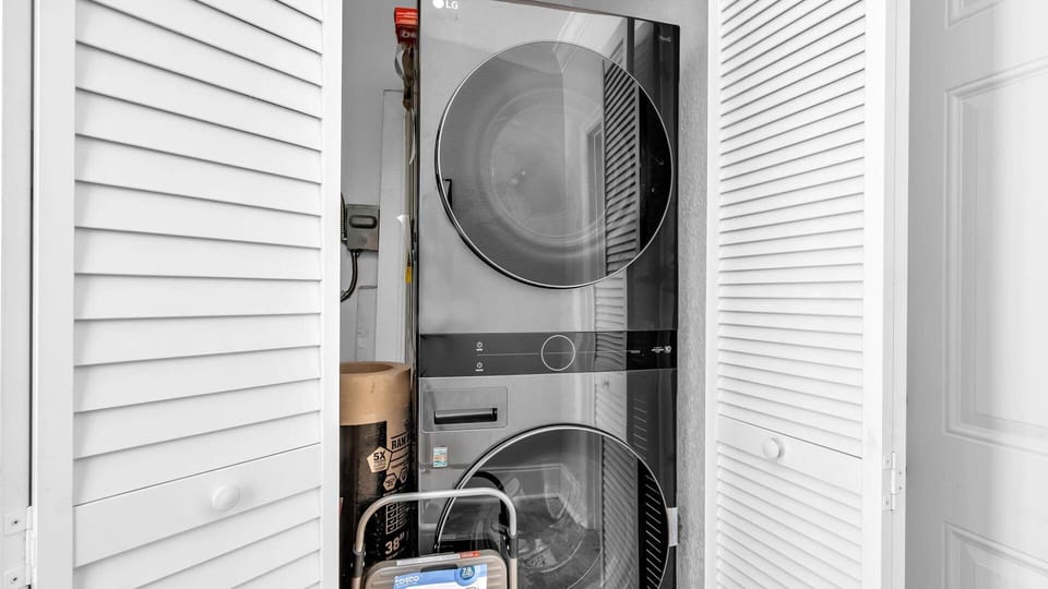 This home includes a sleek, space-saving LG washer and dryer tucked neatly into a hallway closet—perfect for extended stays or keeping beachwear fresh throughout your trip.