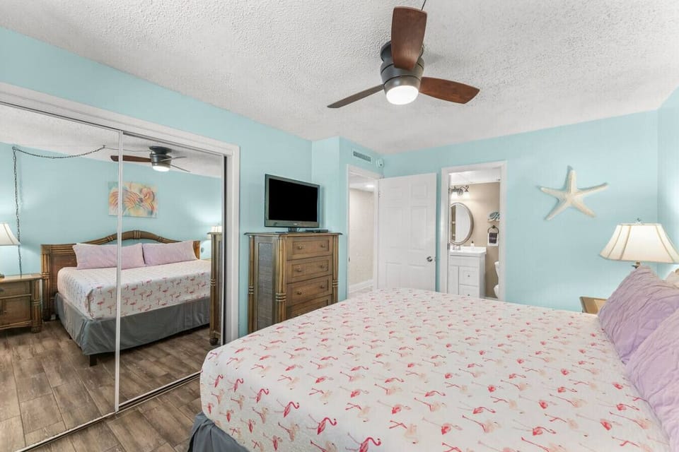 Primary Bedroom with King Size Bed, Dresser, Closet, Flat Screen TV and Ensuite Bathroom