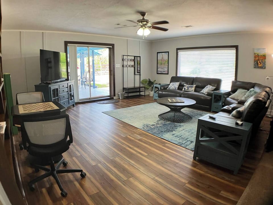 Large spacious living room with comfortable leather reclining couches and lots of floor space!
