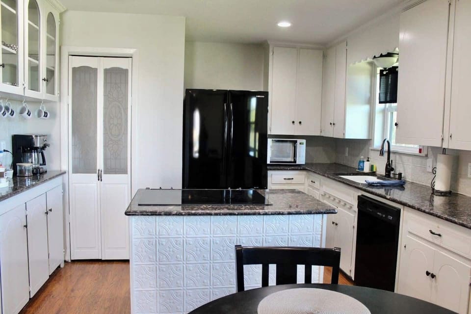 Where refreshment and relaxation meet! Imagine cooking in this fully equipped kitchen with ample counter space and stainless steel appliances—perfect for gourmet meals.