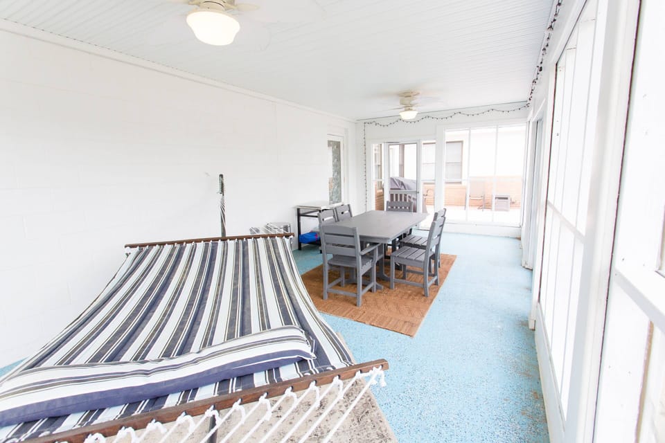 Take a nap on the hammock at Lorraine's without worrying about bugs or rain on this screened porch