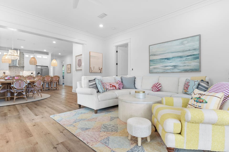 Bright and airy living room with comfortable seating, TV and easy outdoor access.