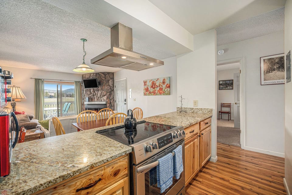 - Fully equipped kitchen with granite countertops and stainless appliances
- Center island features built in cooktop and flows into the dining area
- Ideal setup for cooking while staying connected with your group