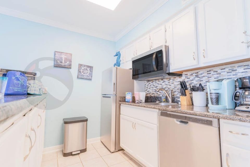 Kitchen with fridge, microwave, 2 burner cooktop and microwave