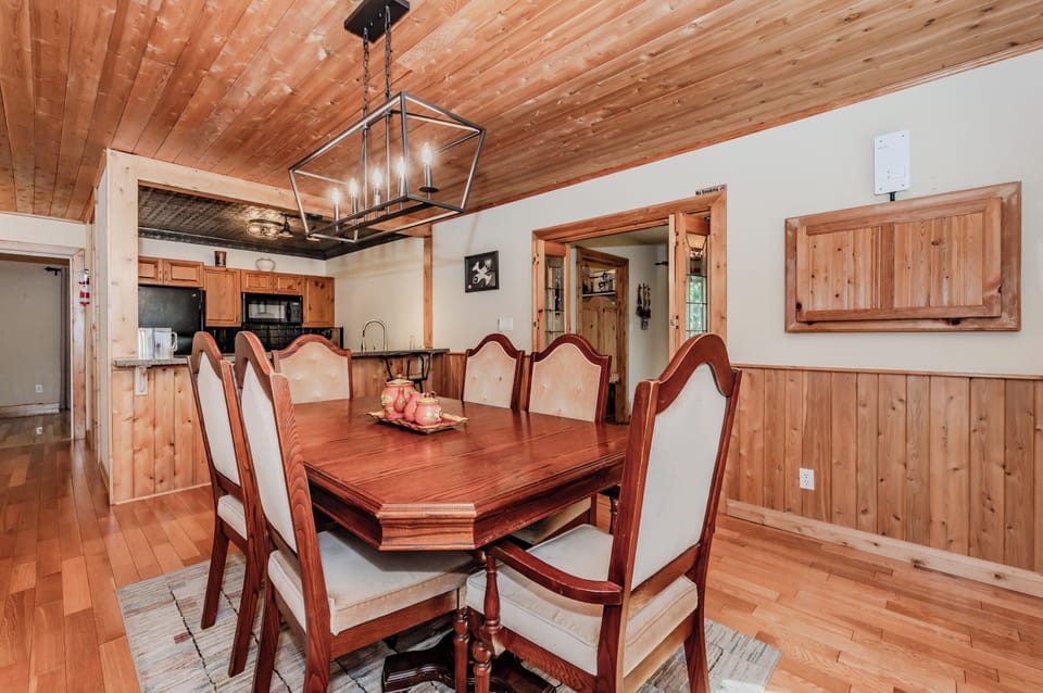Gather around a large family dining table next to a rustic kitchen—perfect for home-cooked meals on your nature escape.
